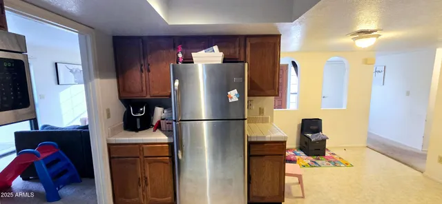 a kitchen with refrigerator a washer and dryer