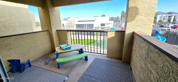 a balcony with furniture and rug