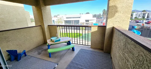 a balcony with furniture and rug