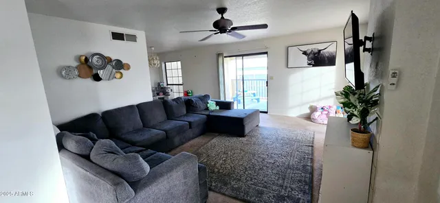 a living room with furniture and a potted plant