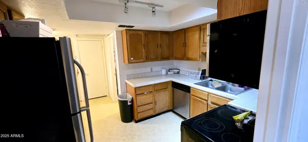 a utility room with cabinets washer and dryer