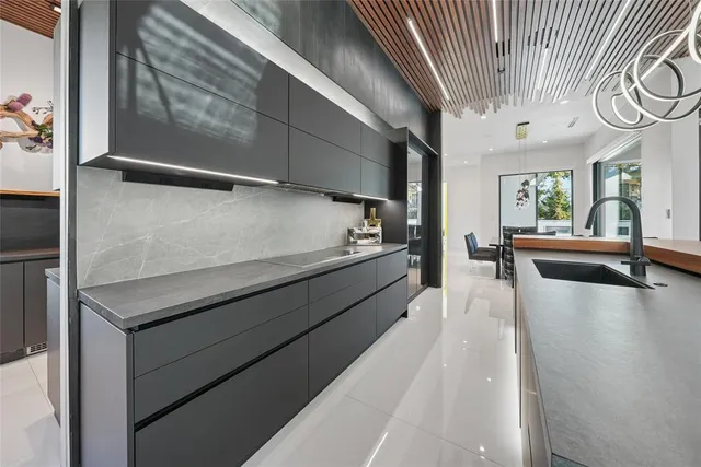 a large white kitchen with a large window