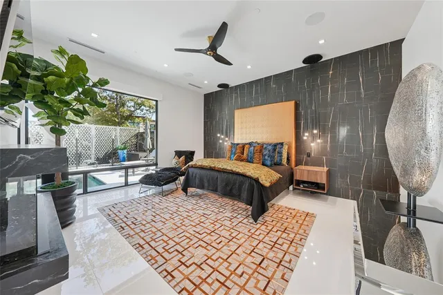 a bedroom with a large bed and a potted plant