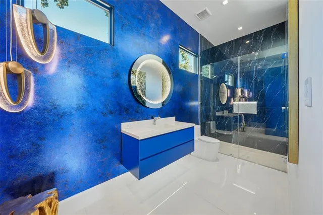 a bathroom with a sink mirror and vanity
