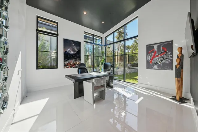 a dining room with furniture and a large window