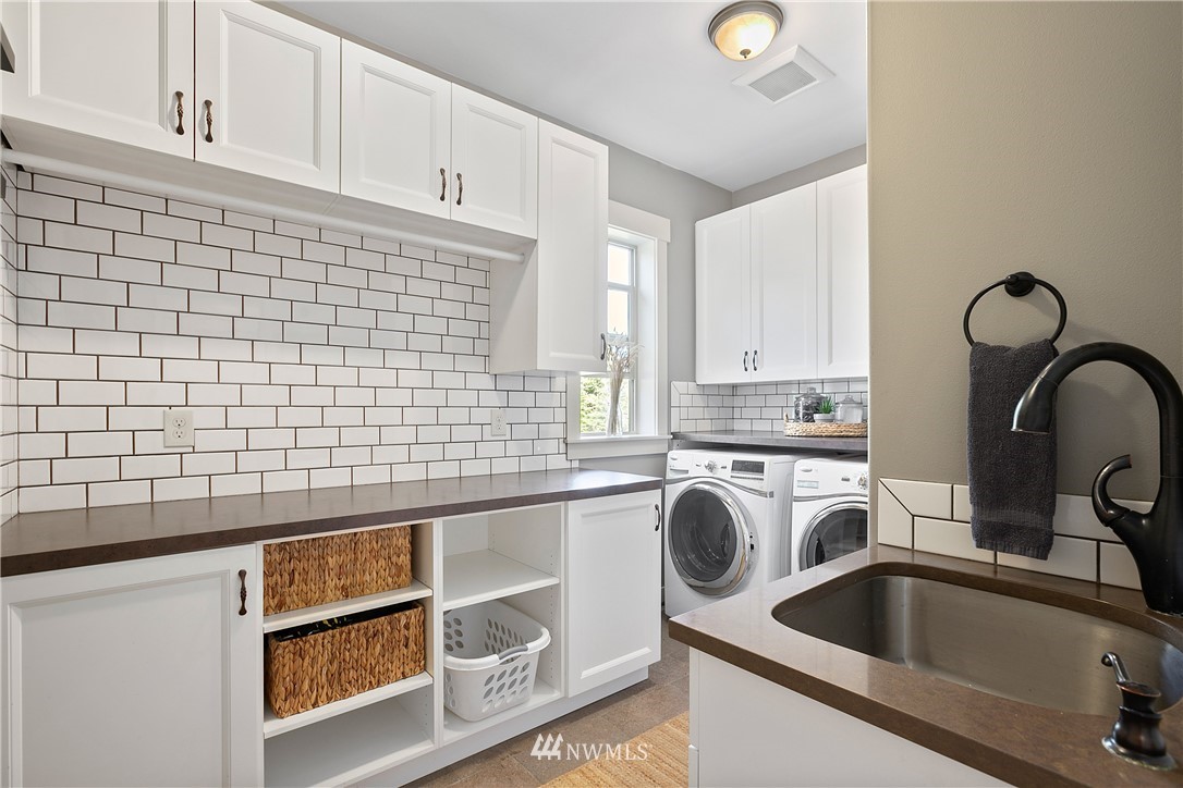 5745 Barr Road Ferndale, WA 98248 - Photo 13 of 40 a kitchen with a sink and a washer dryer