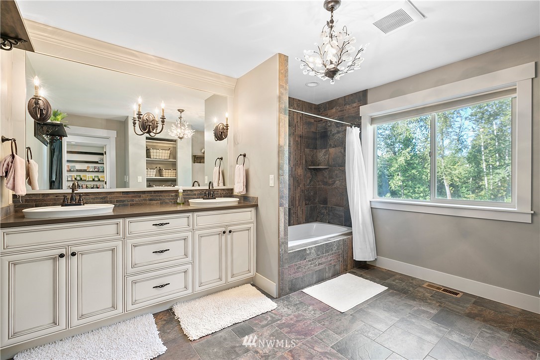 5745 Barr Road Ferndale, WA 98248 - Photo 24 of 40 a spacious bathroom with a shower a sink and a large mirror