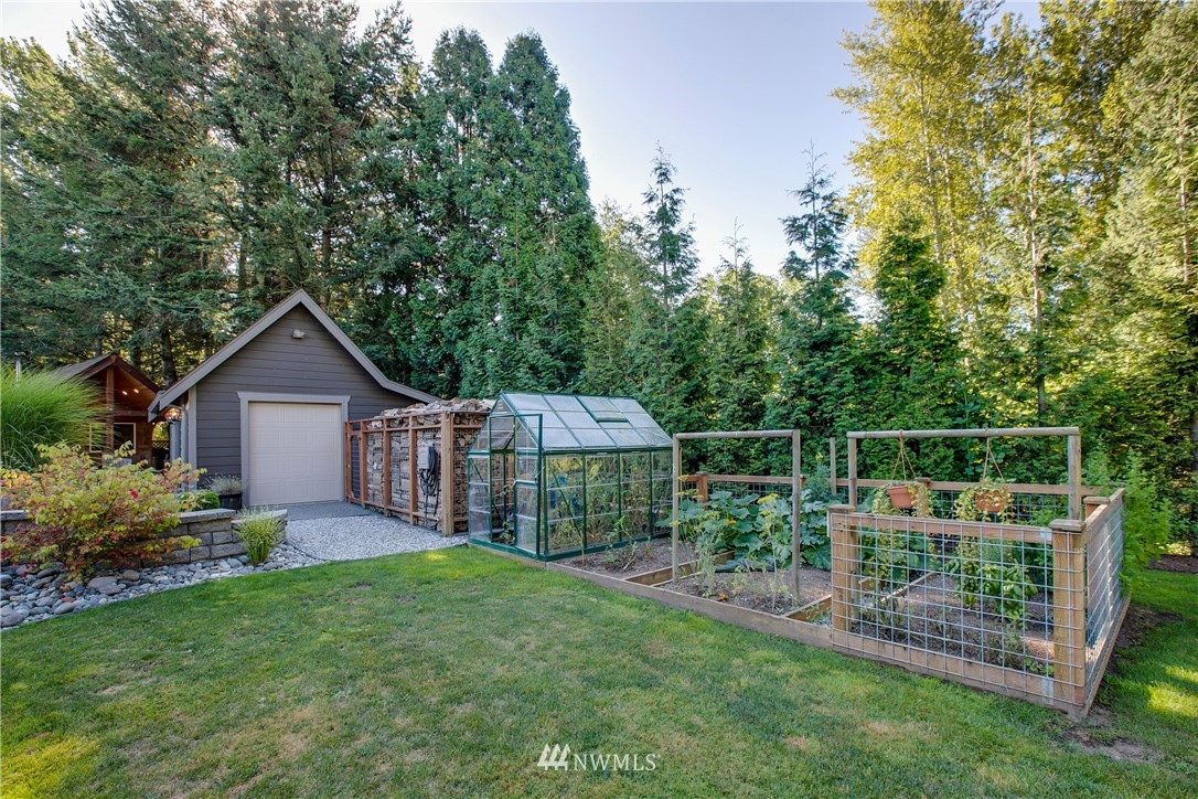 5745 Barr Road Ferndale, WA 98248 - Photo 31 of 40 a front view of a house with garden and trees