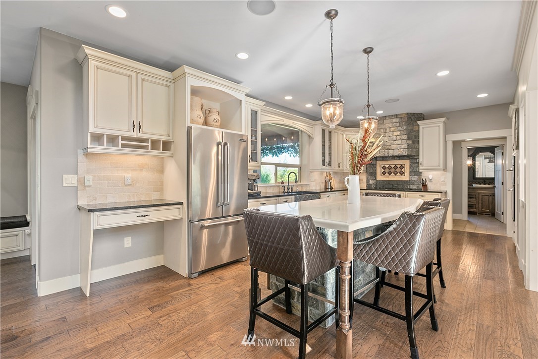 5745 Barr Road Ferndale, WA 98248 - Photo 8 of 40 a kitchen with stainless steel appliances granite countertop a refrigerator a oven a white dining table and chairs with wooden floor