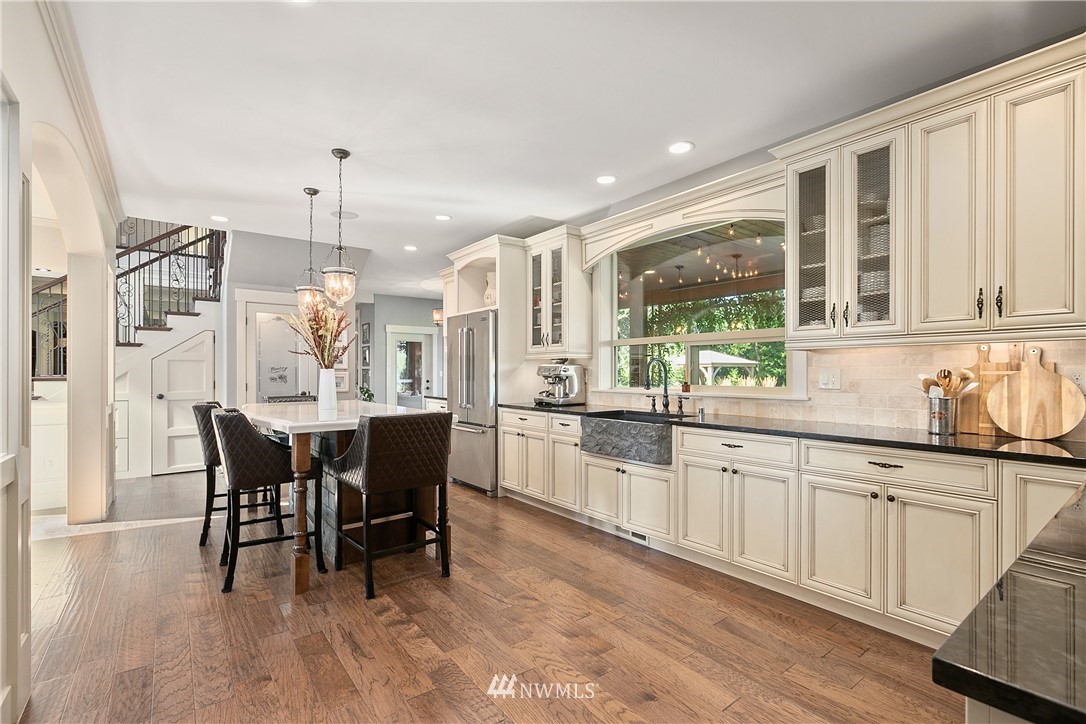 5745 Barr Road Ferndale, WA 98248 - Photo 10 of 40 a open kitchen with granite countertop a dining table chairs and white cabinets