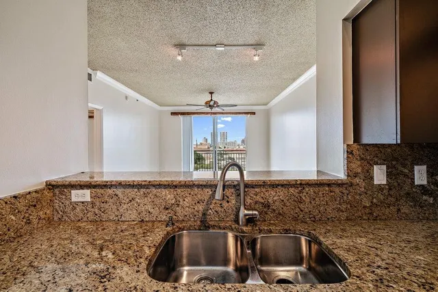 a kitchen with a sink and a stove top oven