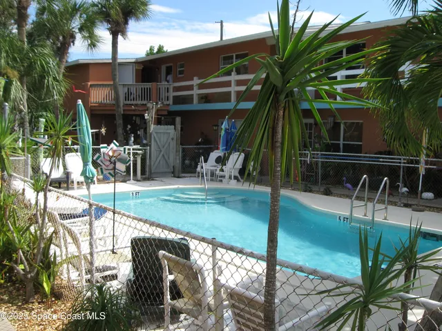 a view of outdoor kitchen and dining area