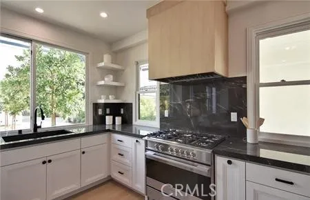 a living room with furniture flowerpot and a chandelier