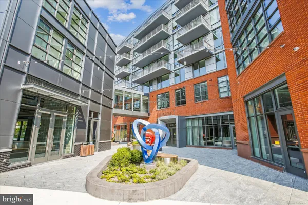 a living room with furniture a large window and a dining table