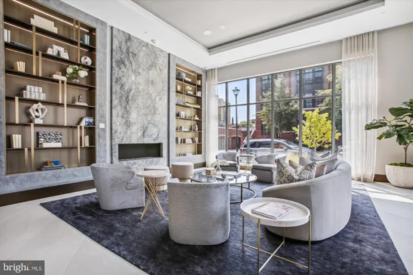a living room with furniture and a floor to ceiling window