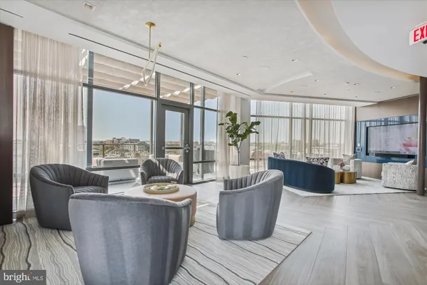 a living room with furniture and large windows