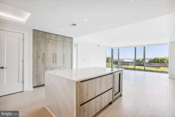 a kitchen with stainless steel appliances granite countertop a refrigerator and a stove