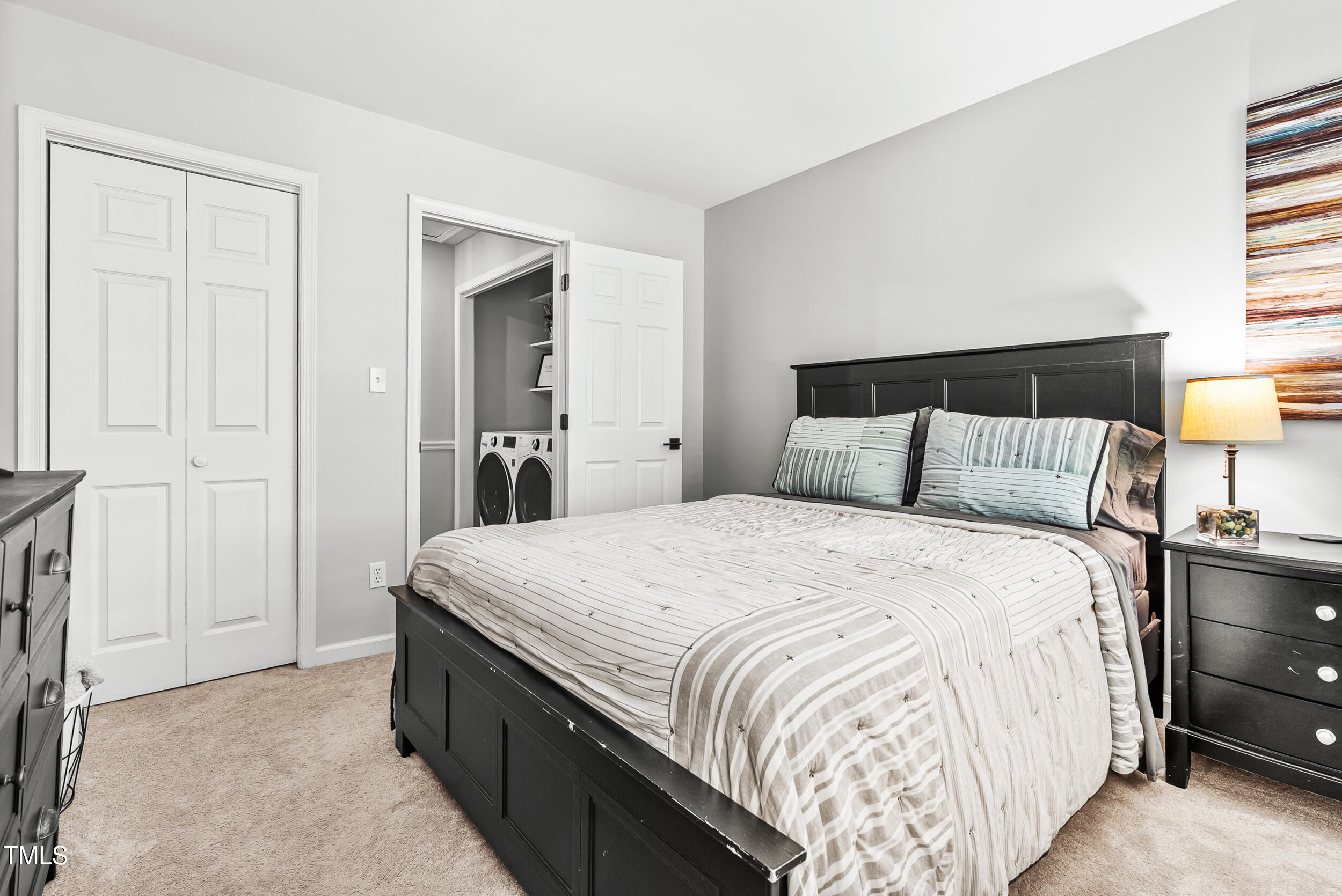 5701 Hadrian Drive Durham, NC 27703 - Photo 22 of 41 a bedroom with a bed and a night stand