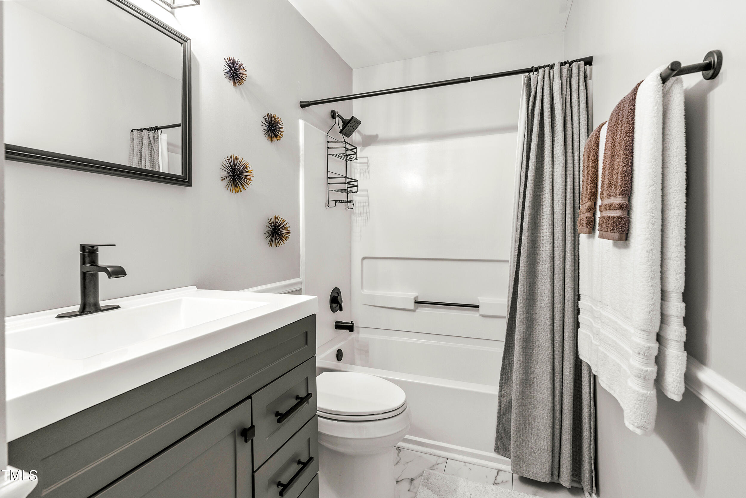 5701 Hadrian Drive Durham, NC 27703 - Photo 24 of 41 a bathroom with a sink toilet and shower
