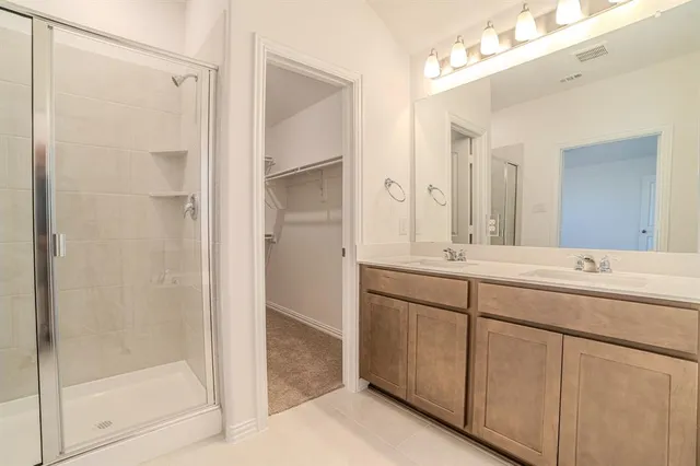 an empty room with a chandelier fan