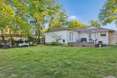 a view of a house with backyard sitting area and garden