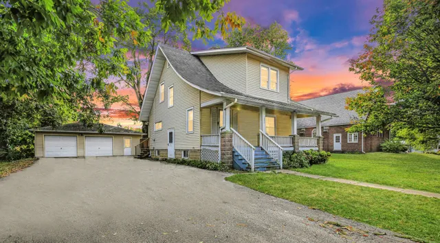a view of a big yard with plants and large trees