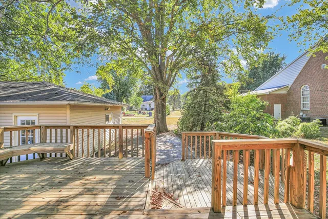 a view of an entryway with wooden floor and door