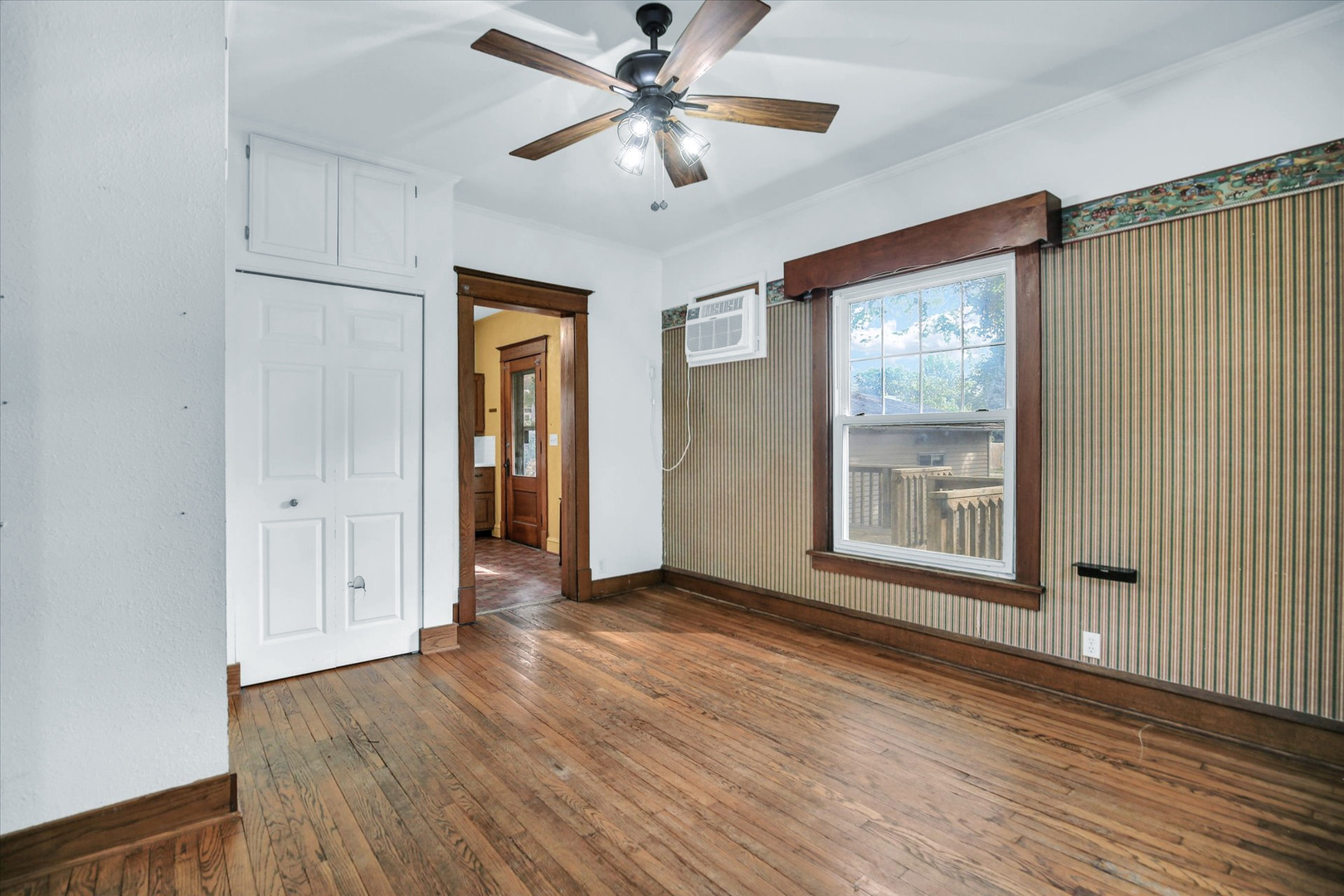 206 Illinois Street Mansfield, IL 61854 - Photo 31 of 74 a view of an empty room with a window and wooden floor
