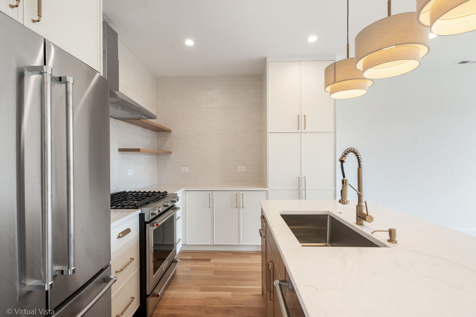 1530 West 18th Place, Unit 2 Chicago, IL 60608 - Photo 3 of 15 a kitchen with stainless steel appliances granite countertop a sink and a stove
