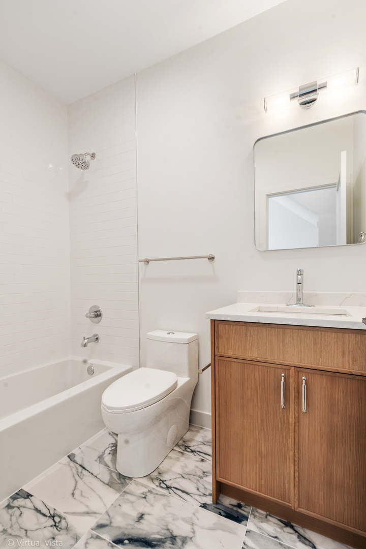 1530 West 18th Place, Unit 2 Chicago, IL 60608 - Photo 10 of 15 a bathroom with a sink toilet and shower