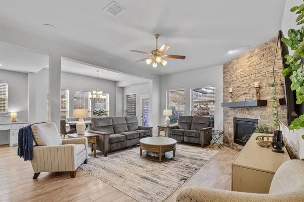 a living room with furniture a flat screen tv and a fireplace