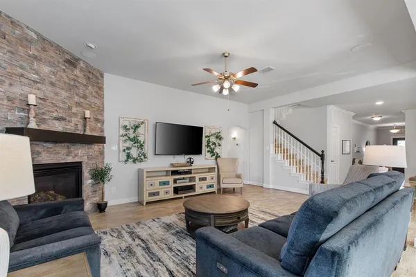 a living room with furniture fireplace and a large window