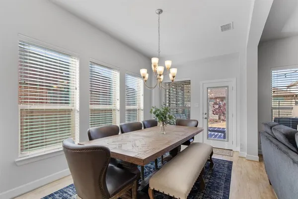 a living room with furniture a chandelier and a dining room