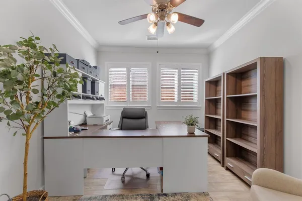 a dining room with wooden floor a chandelier a wooden table and chairs
