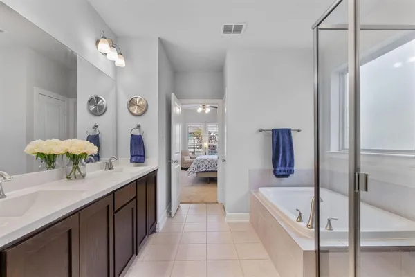 a bathroom with a bathtub and a shower