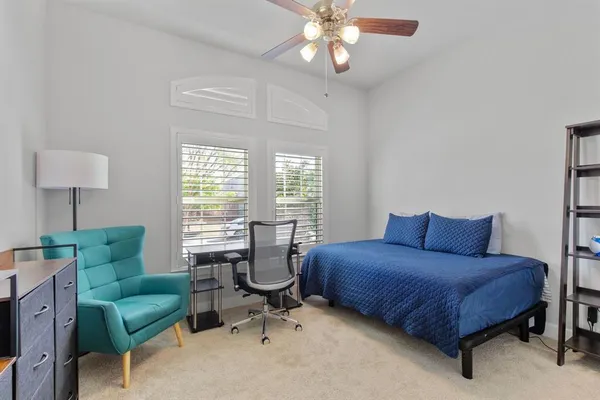 a spacious bathroom with a granite countertop sink mirror and bathtub