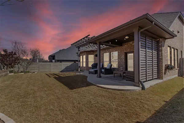 a view of the house with backyard and porch