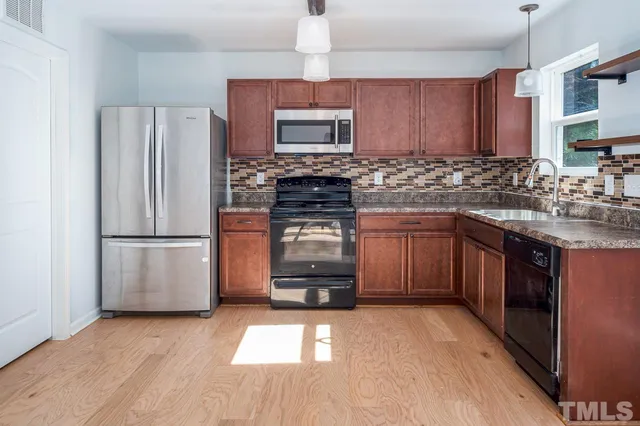 a kitchen with a refrigerator stove and sink