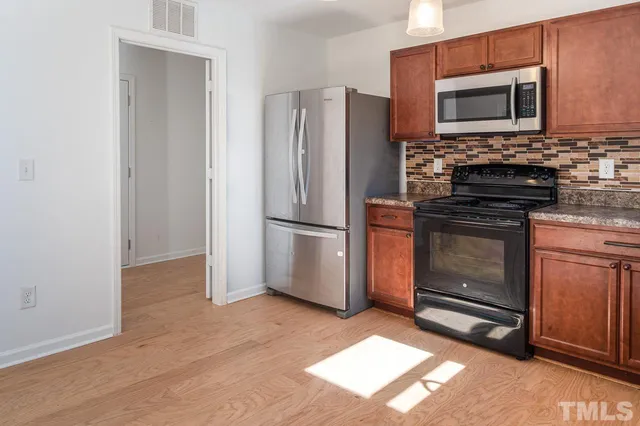 a kitchen with a refrigerator stove and microwave