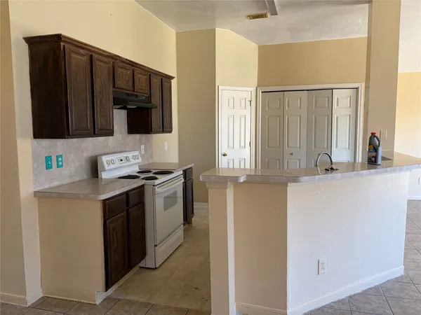 a kitchen with stainless steel appliances granite countertop a sink and a refrigerator