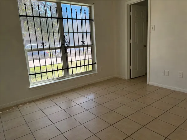 a view of an empty room and a window