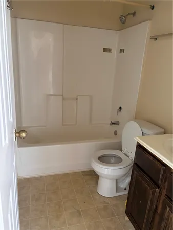 a white toilet sitting next to a bathroom sink