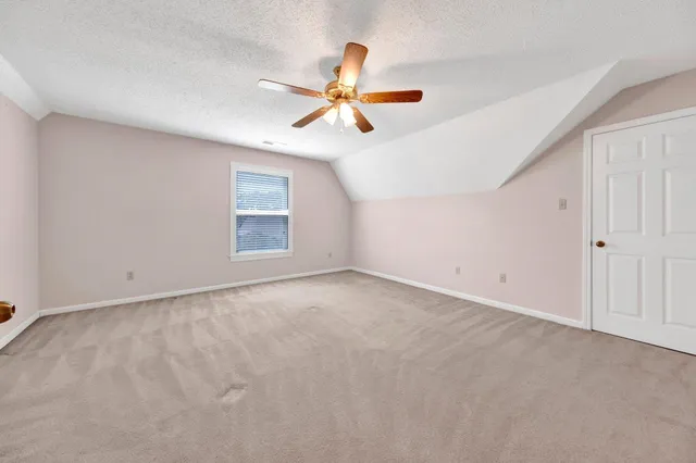 a view of an empty room with a ceiling fan