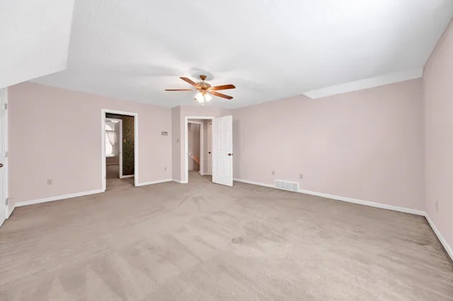 a large spacious bathroom with a tub sink shower and mirror