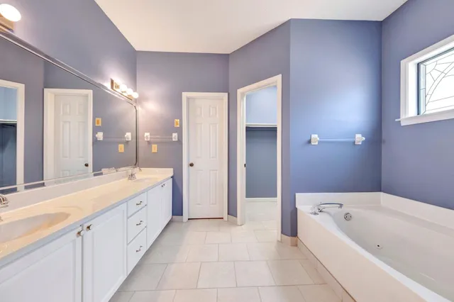 a spacious bathroom with a double vanity sink shower and a mirror