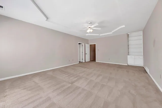 a bathroom with a granite countertop sink a toilet and shower