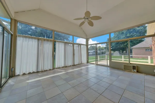 a view of a house with a yard and pathway