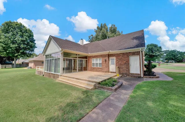 a view of a house with a yard and sitting area