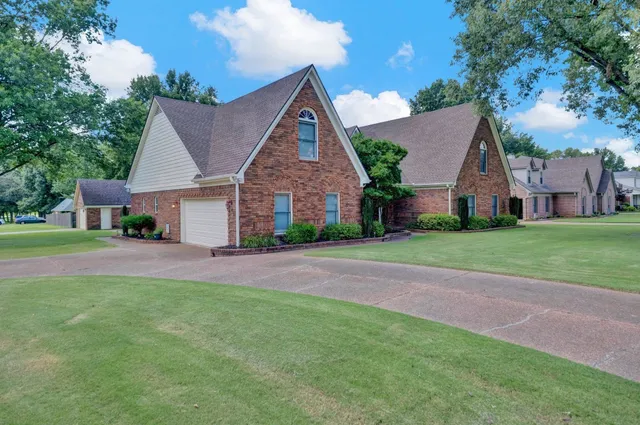 a front view of house with yard and green space