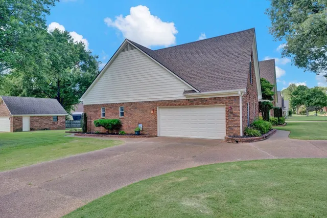 a front view of a house with a yard and a garage